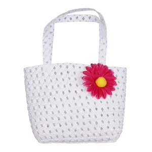 Detailed view of children white woven handbag with a 3D pink daisy flower accessory