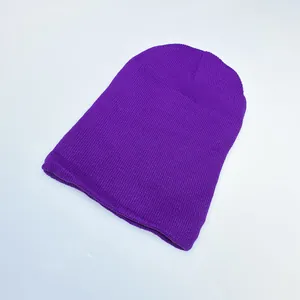 Detailed close-up of purple knit beanie texture and stitching on a neutral background