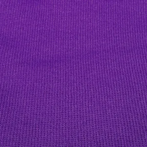Close-up of the purple knitted fabric texture showing thick honeycomb stitching