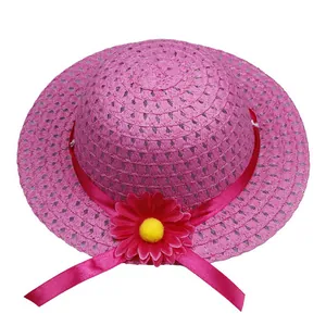 Detailed view of woven straw hat with red ribbon and large floral accent for kids