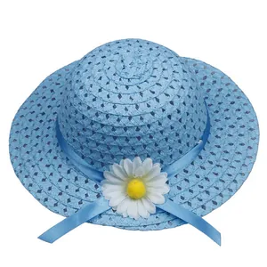 Detailed view of sky blue straw sun hat with woven texture and a white daisy floral accent