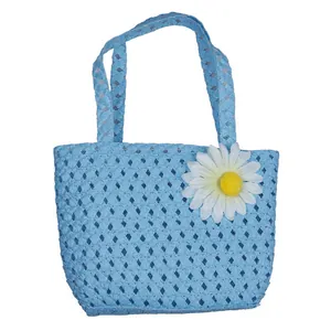 Blue woven straw tote bag for kids with white daisy flower detail for summer beach use