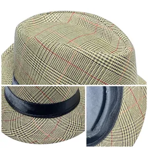 Macro detail of plaid texture and black satin ribbon on men's summer trilby fedora hat