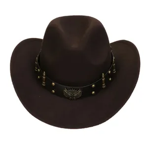 Detail of vintage cowboy hat featuring brass eagle emblem and bullet charms on band