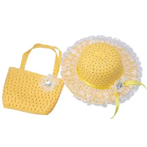 Detail of yellow straw sun hat and matching handbag with lace trim and flower accents