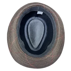 Detailed view of the size 58 label and cotton blend fabric on the dark brown fedora hat