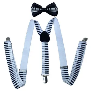 Detailed view of Y-back elastic suspenders and bowtie with piano keyboard pattern print