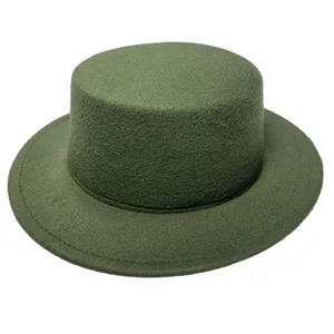 Detail of dark green wool felt boater hat featuring a flat brim and stitched edge