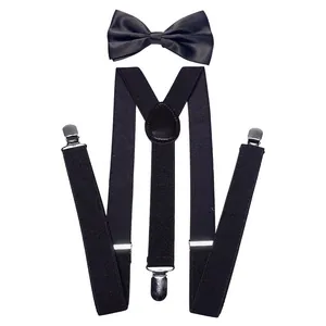 Detail view of black bow tie and Y-back suspenders with silver metal clips and leather joint