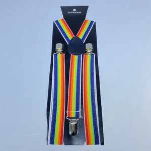 Detailed close-up of rainbow striped elastic suspenders with silver metal clips on packaging