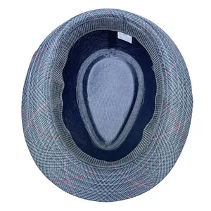 Macro view of blue plaid fedora interior showing the sweatband and material label