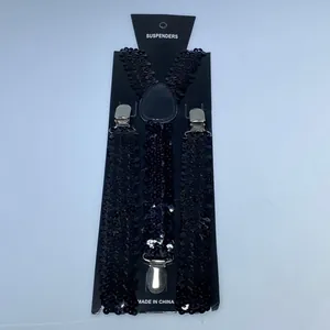Detail of Y-shape black sequin suspenders with three silver clips on display card