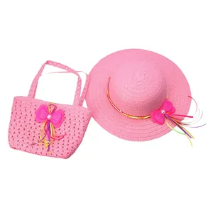 Detailed view of pink straw hat and handbag set with ribbon bows and pearls for kids