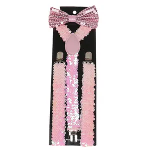 Close-up of pink sequin bowtie and Y-back suspenders set with silver metal clips
