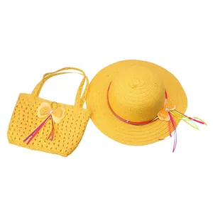 Detail of yellow straw sun hat and matching handbag set with bows and pearls for kids