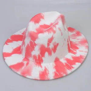 Close-up of tie-dye wool fedora hat with wide brim and pink artistic texture