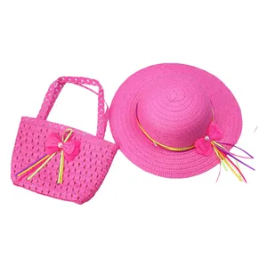 Detail of rose red straw sun hat and matching handbag set with colorful bow and pearl accents