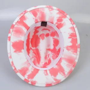 Detail of red tie-dye fedora interior showing 65% cotton blend label and pink sweatband