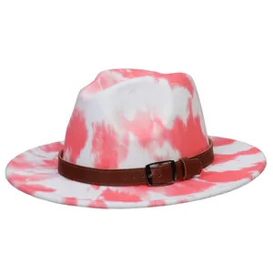 Detailed view of pink tie-dye fedora featuring a dark brown leather band and buckle