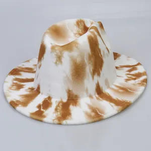 Detail of tie-dye fedora showing the brown and white fabric texture and reinforced stitching