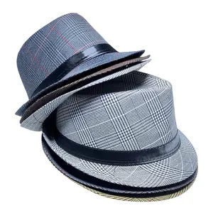 Detail showing stacked grey plaid fedora hats with textured fabric and black bands