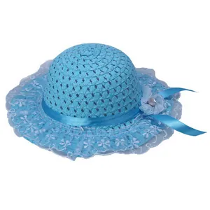 Detail of blue straw hat with white lace wavy brim and decorative floral ribbon