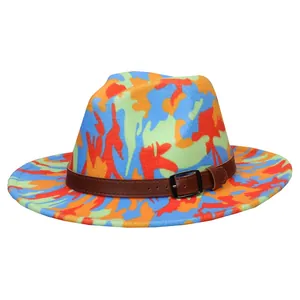 Close-up of tie-dye jazz fedora with camouflage pattern and brown faux leather buckle belt