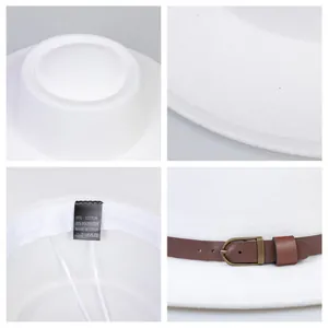 Detail view of white flat top boater hat featuring brown leather band and stitching