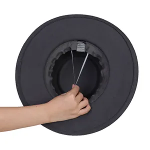 Detail view of adjustable inner drawstring and fabric label on black wool fedora hat