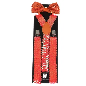Detail of bright orange sequin bowtie and suspenders set with metallic clips on display card