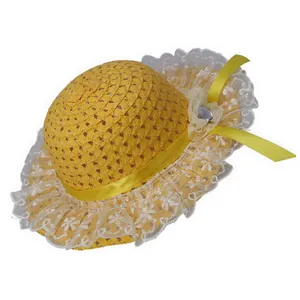 Detail of yellow straw sun hat featuring elegant white lace trim and flower ribbon decor