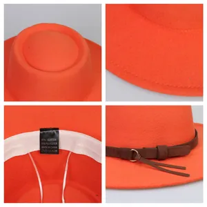 Detail view of orange wool fedora showing 65% cotton fabric label and adjustable strap