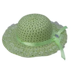 Detail of light green straw hat with white lace trim and floral ribbon decoration