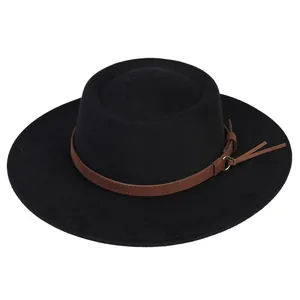 Detail of black wool fedora featuring a brown leather band and gold metal ring buckle