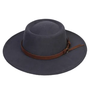 Close-up of wide brim fedora hat with brown leather strap and metallic buckle detail