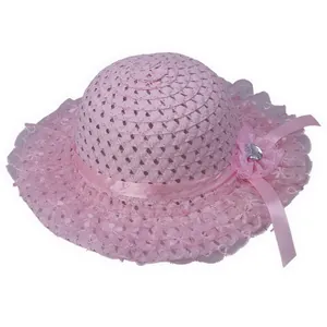 Detail view of pink straw hat with delicate lace brim and ribbon flower for girls