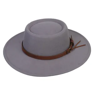 Detail view of the flat top wide brim felt hat featuring a brown leather decorative band