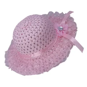 Detail of pink straw sun hat for girls with lace trim and elegant floral ornament