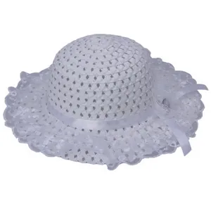 Detail of white hollow crochet sun hat with delicate lace edges and a silk ribbon bow