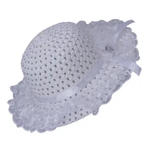 Close-up of white woven straw hat featuring delicate lace brim and mesh flower detail