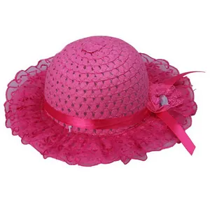 Detail of girls' bright pink straw hat with lace brim, fabric flower and ribbon bow