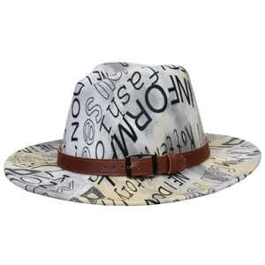 Detail of fedora hat with ink tie-dye letters pattern and brown faux leather belt buckle