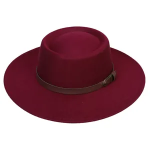 Detail of burgundy wool fedora hat featuring a brown leather band and metallic buckle