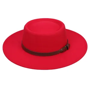 Detail of red wool felt boater hat with dark brown leather band and metallic buckle