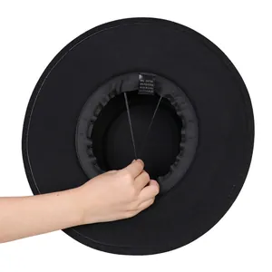 Detail of adjustable inner drawstring and sweatband inside black wool fedora hat