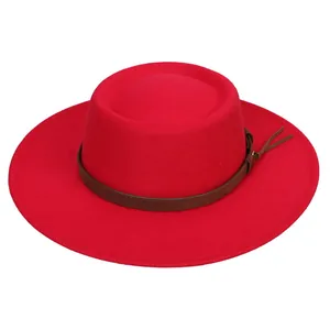 Detail of red flat top wool fedora hat featuring a thin brown leather decorative band