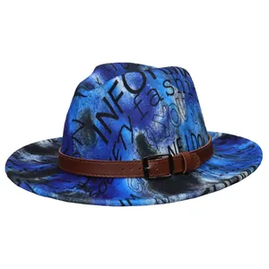 Close-up of tie-dye fedora with graffiti text print and brown leather buckle band