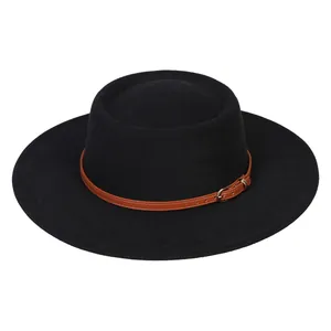 Detail of black wide brim wool hat featuring brown leather band and metal buckle