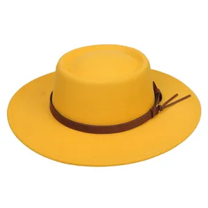 Detail of yellow wool felt fedora with a brown leather decorative band and fringe