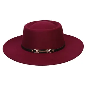 Close-up of wine red flat top wool felt fedora hat with black band and gold buckle